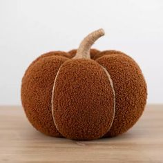 a brown pumpkin sitting on top of a wooden table