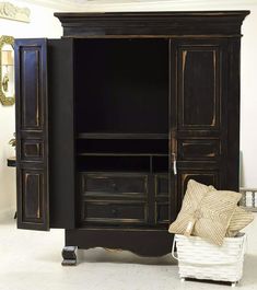 the armoire is black with gold trimmings