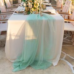 the table is set with flowers and candles