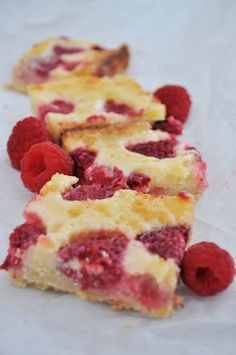 a cheesecake with raspberries on a plate