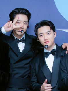 three young men in tuxedos posing for a photo with their headsets on