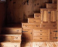 there are many drawers on the stairs in this house