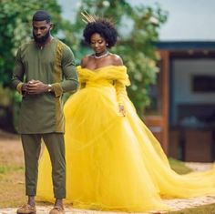 a man and woman dressed in yellow standing next to each other