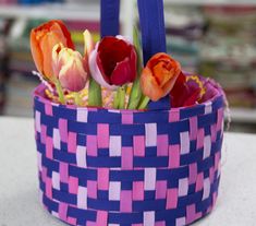 a basket filled with flowers sitting on top of a table