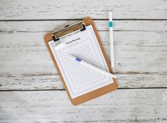 a clipboard with a pen and paper on it sitting next to a toothbrush