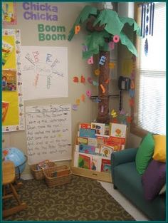 a child's room with a palm tree in the corner and bulletins on the wall