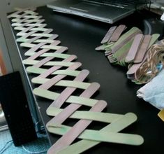 some toothbrushes are lined up on a table next to a laptop and other items