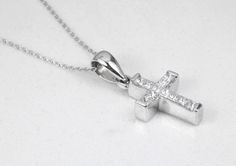 A token of faith. An 18k white gold cross showcases 11 stunning, princess cut diamonds, channel set. Each diamond is near colorless with 100% clean eye clarity. This pendant is a perfect size, not too small but big enough to be noticed and adored. This gorgeous diamond cross necklace is perfect for everyday use. It is an ideal gift to oneself or to someone you love! An inch 18K white gold cable chain is included with this diamond cross. Metal Purity: 18K White Gold (stamped behind bale: 18K) Set Fine Jewelry White Gold Cross Necklace For Anniversary, White Gold Cross Necklace With Cubic Zirconia, Formal Silver Diamond Cross Necklace, White Cross Necklace With Diamond Accents For Formal Events, White Cross Necklace With Diamond Accents For Formal Occasions, Formal White Cross Necklace With Diamond Accents, White Gold Diamond Cross Necklace Gift, White Gold Cubic Zirconia Cross Necklace For Anniversary, Anniversary White Gold Cubic Zirconia Cross Necklace