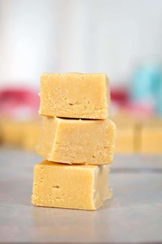 three pieces of yellow fudge sitting on top of a table