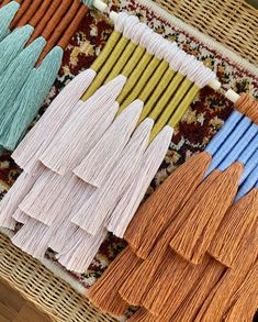 several different colors of tassels laid out on a rug