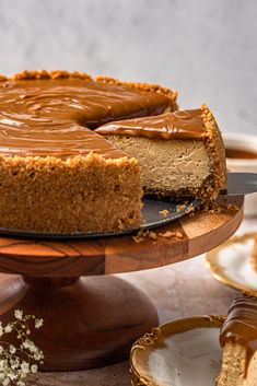 a chocolate cheesecake on a wooden cake stand