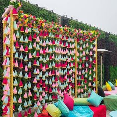 an outdoor seating area decorated with colorful pillows