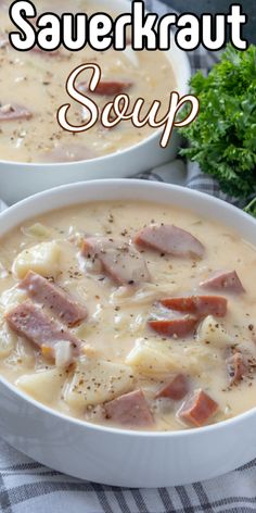 two white bowls filled with soup on top of a table