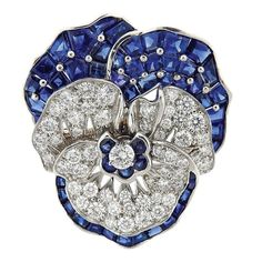 Iconic platinum pansy flower brooch, crafted by Oscar Heyman, decorated with approximately 3.25ctw in diamonds and 9.00ctw in blue sapphires. MATERIAL: Platinum DIMENSIONS: 35mm x 33mm GEMSTONES: Sapphire, Diamond WEIGHT: 23.8 grams MARKED/TESTED: pt900, 10% irid, Marker's Mark, 200174 CONDITION: Estate PRODUCT ID: IN606 Pansy Flower, Kay Jewelry, Pansies Flowers, Blue Sapphire Diamond, Diamond Brooch, Sapphire Diamond, Flower Brooch, Vintage Jewellery, Turquoise Jewelry