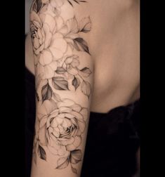 a woman's arm with flowers on it