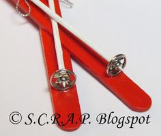 two red and white toothbrushes with metal clips