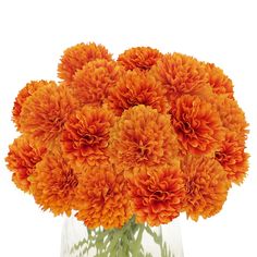 a vase filled with orange flowers on top of a table