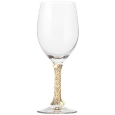 an empty wine glass with gold glitter on the rim and bottom, sitting in front of a white background