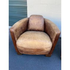 a brown chair sitting on top of a blue carpet