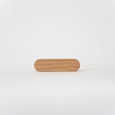 a wooden object on a white surface with no one around it or in the background