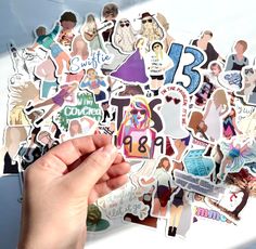 a person holding up a bunch of stickers