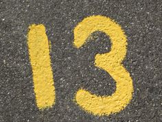 the number thirteen is painted on the asphalt