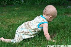 a baby is crawling in the grass