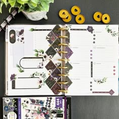 the contents of a planner spread out on a table next to a potted plant