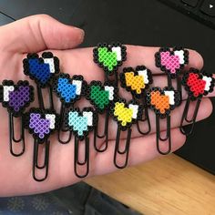 a person is holding several pieces of pixelated hair clips