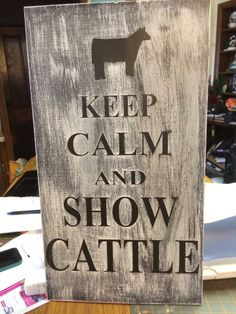 a sign that says keep calm and show cattle