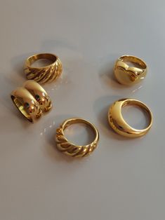 Because a lot of customer-friends love chunky rings, I made a collection of my wide rings. I hope you love these big golden rings. ♥ SIGN UP for 10% OFF your first order: https://bit.ly/3olIlWf ♥ DETAILS - Materials: Stainless steel, 18k gold plating. - Nickel-free, anti-corrosion, tarnish-resistant, and hypoallergenic. - Safe for sensitive skin. - Waterproof Ring: you can wear it while taking a shower or washing your hands. ♥ STYLE ⇨ A - Croissant Ring ⇨ B - Double Dome Ring ⇨ C - Themis Ring ⇨ Thick Ring Gold, Dome Rings Gold, Gold Chunk Jewelry, Lots Of Gold Rings, Chunky Rings Women, Bulky Gold Rings, Gold Right Hand Rings, Gold Y2k Rings, 18k Gold Rings