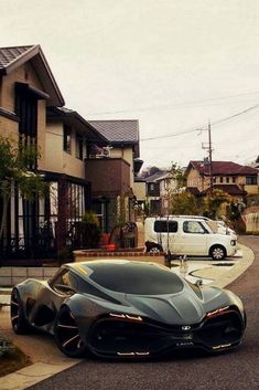 a very nice looking car parked on the side of the road in front of some houses