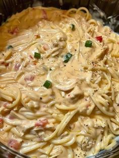 a bowl filled with pasta and sauce on top of a table