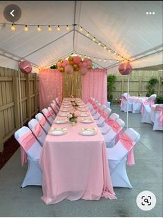 a table set up for a party with pink and white linens on the tables