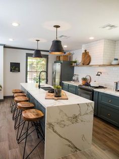 a kitchen with marble counter tops and wooden stools