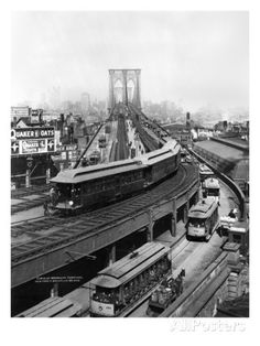 an old black and white photo of a train on the tracks in front of a bridge