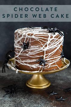 a chocolate spider web cake on a gold plate