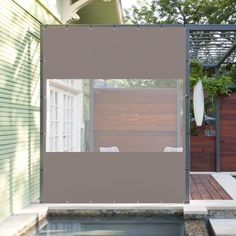 a house with a pool in front of it and a screen on the outside wall