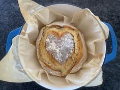 a heart shaped loaf of bread in a bowl