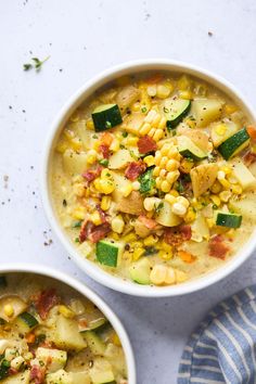 two white bowls filled with corn and vegetable soup