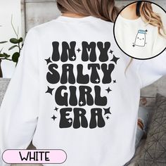 Are you in your salty girl era? There's nothing funny about it, but sometimes laughter is the best medicine and I like to take a lighthearted approach to dealing with my own chronic illness. If you can relate to putting salt on almost everything per doctor's orders, this comfy sweatshirt is perfect for you.  This crewneck sweatshirt is pure comfort. Made from a soft cotton/poly blend with no itchy side seams, this is sure to become a staple. SIZE AND FIT: Your sweatshirt design will be printed o White Long Sleeve T-shirt With Funny Text, White Long Sleeve Sweatshirt With Funny Text, White Long Sleeve Tops With Funny Text, Funny White Sweatshirt With Text Print, Retro White Tops With Lettering, Funny White Relaxed Fit Sweatshirt, White Relaxed Fit Funny Sweatshirt, Cute White Slogan Sweatshirt, White Sweatshirt With Funny Print