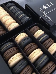 an open box of macaroons sitting on top of a table