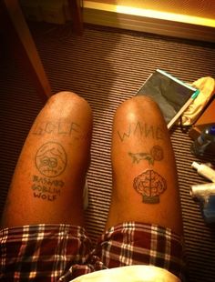 two people with tattoos on their legs