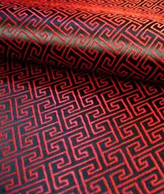 red and black fabric with an intricate design