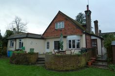 a house with a garden in front of it and an outside patio area next to the house