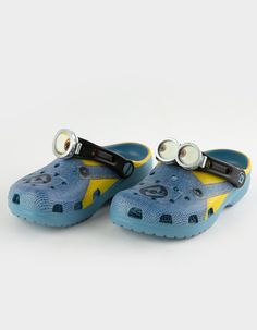 Crocs X Minions Clogs. Bello! The Minions Classic Clog Is Designed To Look Like Your Favorite Yellow Character, Complete With Printed Denim Overalls. The Ankle Strap Features An Eyeball With Goggles, To Top Off The Essential Minions Look. Minions Logos Adorn The Rivet And Heel, While The Entire Design Is Supported By The Iconic Comfort Of Crocs. Incredibly Light And Fun To Wear. Custom-Printed Minions Outfit Graphic. Molded Tpu Eyeball With Goggle On Ankle Strap. Water-Friendly And Buoyant, Weig Non-slip Plastic Slip-on Clogs, Playful Plastic Clogs For The Beach, Playful Plastic Clogs For Beach, Playful Plastic Beach Clogs, Playful Plastic Clogs With Round Toe, Cute Non-slip Plastic Clogs, Casual Closed Toe Plastic Clogs, Blue Non-slip Fun Clogs, Fun Blue Non-slip Clogs