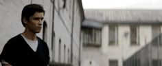 a man standing in front of a white building