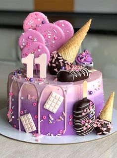 a cake decorated with pink frosting and chocolates