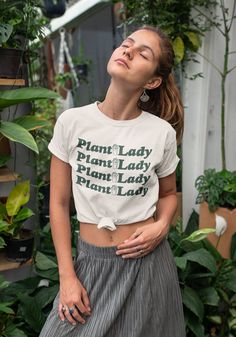 ♥ Made Just for You ♥ Please allow up to 2 weeks for production and delivery. If talking to your plants makes you crazy, then they can lock you up! This neutral tone graphic tee is the perfect t-shirt for the plant parent in you. Rep your inner plant lover and stick up your green thumb in this cute graphic tee. This soft boyfriend fit tee comes in the color Soft Cream, made with 100% combed and ring spun cotton. White model wears size Small. Black model wears size Medium. This is a unisex tee, n Gardening Outfits, Womens Graphic Tees, Plant Parent, Gardening Outfit, Cute Graphic Tees, Weird Shirts, Black Model, Plant Lady, Retro Shirts