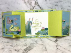 an open card with water lilies and the words go happy to celebrate you on it